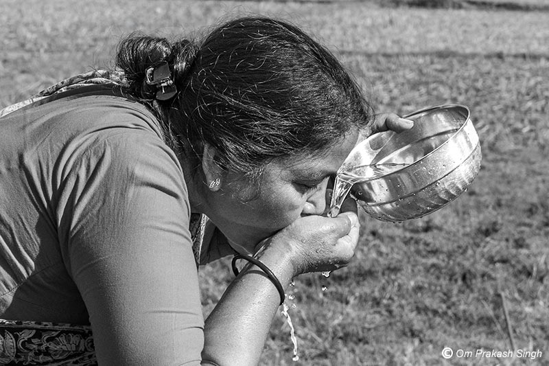 Quenching thirst with water drawn from the Kukuru Daarhi at Jiuri village, Jharkhand, India